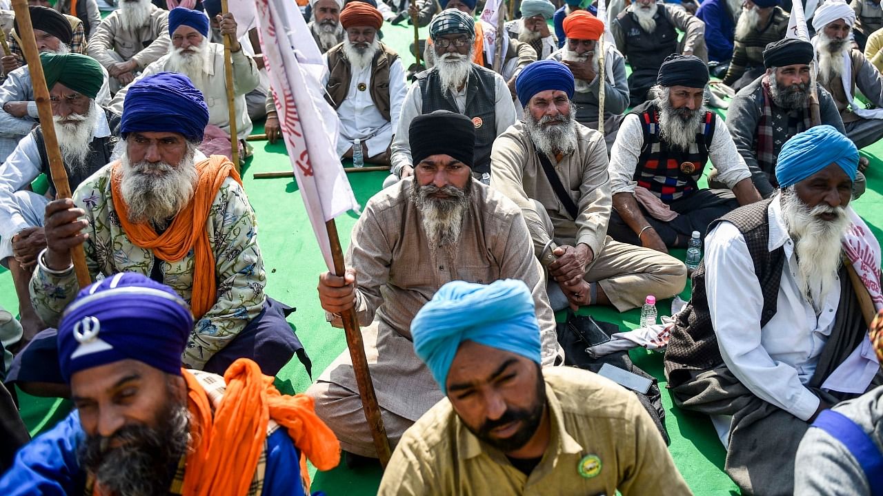 Farmers during their ongoing protest against the new farm laws at Singhu border, in New Delhi. Credit: PTI Photo