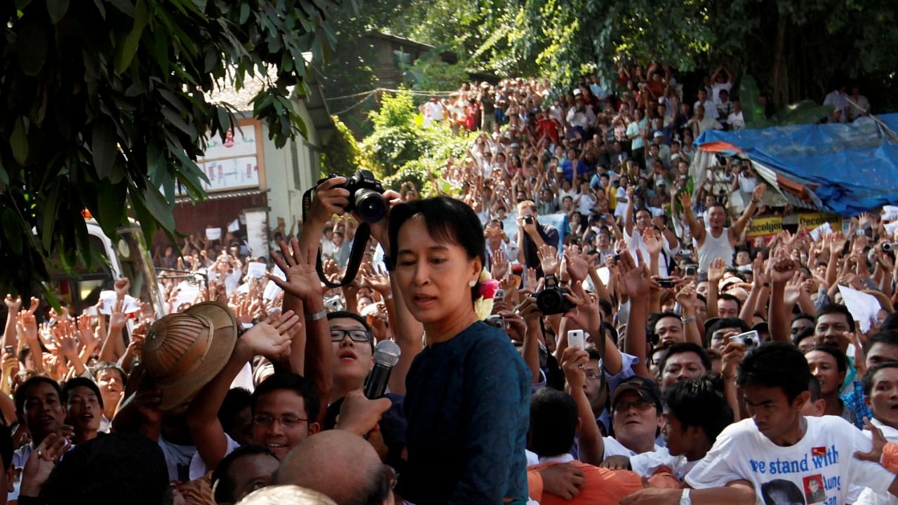 Aung San Suu Kyi stands among supporters gathered to hear her speech outside the headquarters of her National League for Democracy party in Yangon. Credit: Reuters Photo