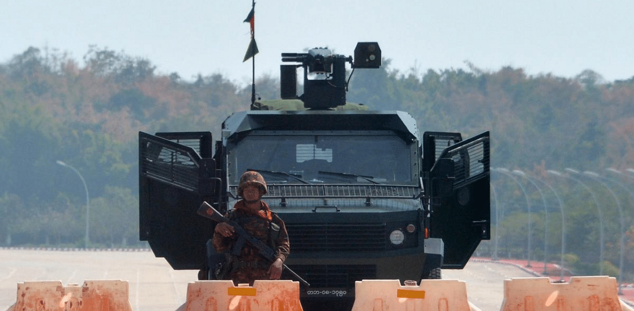 A soldier stands guard on a blockaded road to Myanmar's parliament in Naypyidaw on February 1, 2021, after the military detained the country's de facto leader Aung San Suu Kyi and the country's president in a coup. Credit: AFP Photo