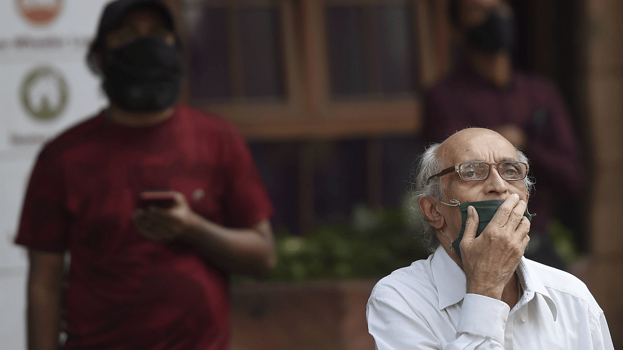 Pedestrians watch stock prices on a digital screen on the facade of Bombay Stock Exchange (BSE), during the Budget Session of the Parliament. Credit: PTI Photo