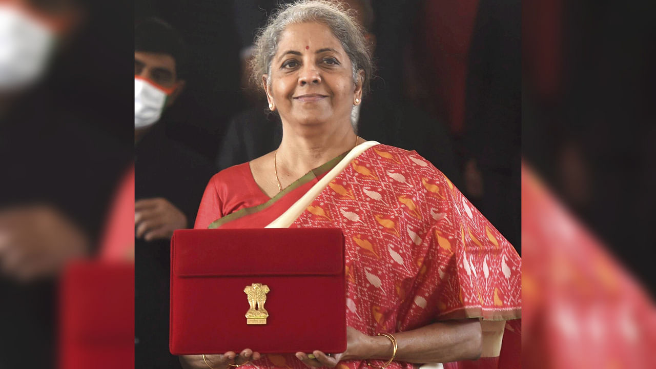 Union Finance Minister Nirmala Sitharaman poses for pictures as she leaves the Finance Ministry to present the annual budget in parliament in New Delhi on February 1, 2021. Credit: PTI Photo