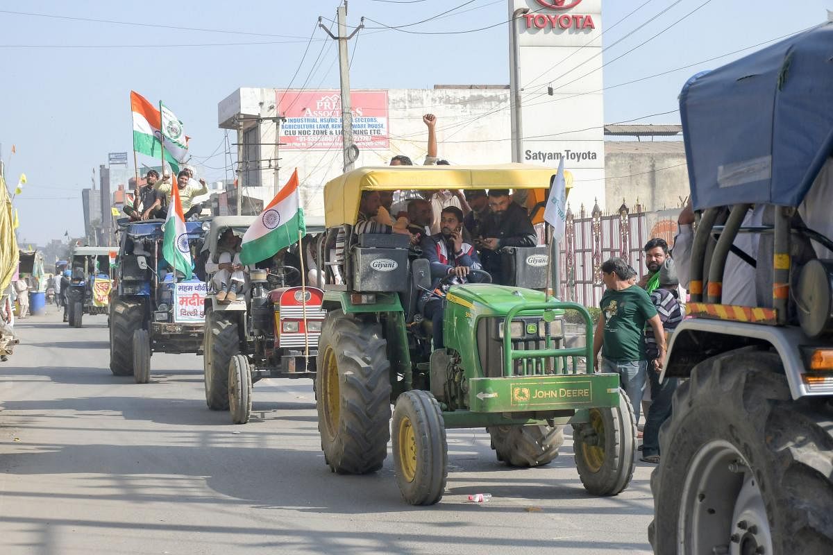 Farmers arrive on tractor at Tikri border. Credit: PTI. 