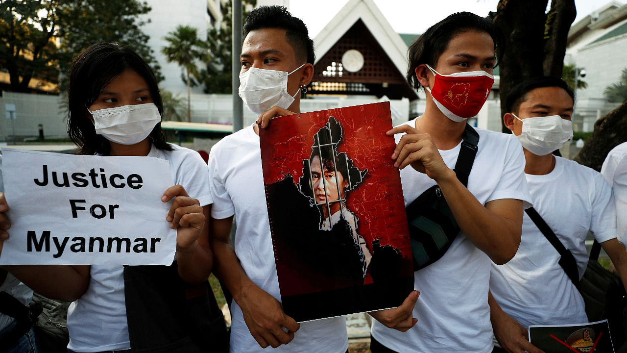 Myanmar citizens hold up a picture of leader Aung San Suu Kyi after the military seized power in a coup in Myanmar, outside United Nations venue in Bangkok, Thailand. Credit: Reuters Photo
