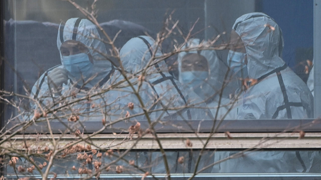 Members of the World Health Organization (WHO) team investigating the origins of the Covid-19 coronavirus, wearing protective gear are seen during their visit to the Hubei Center for animal disease control and prevention in Wuhan. Credit: AFP Photo