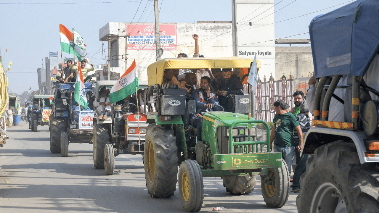 Farmers from different parts of Haryana and Punjab arrive on tractors at Tikri border. Credit: PTI Photo