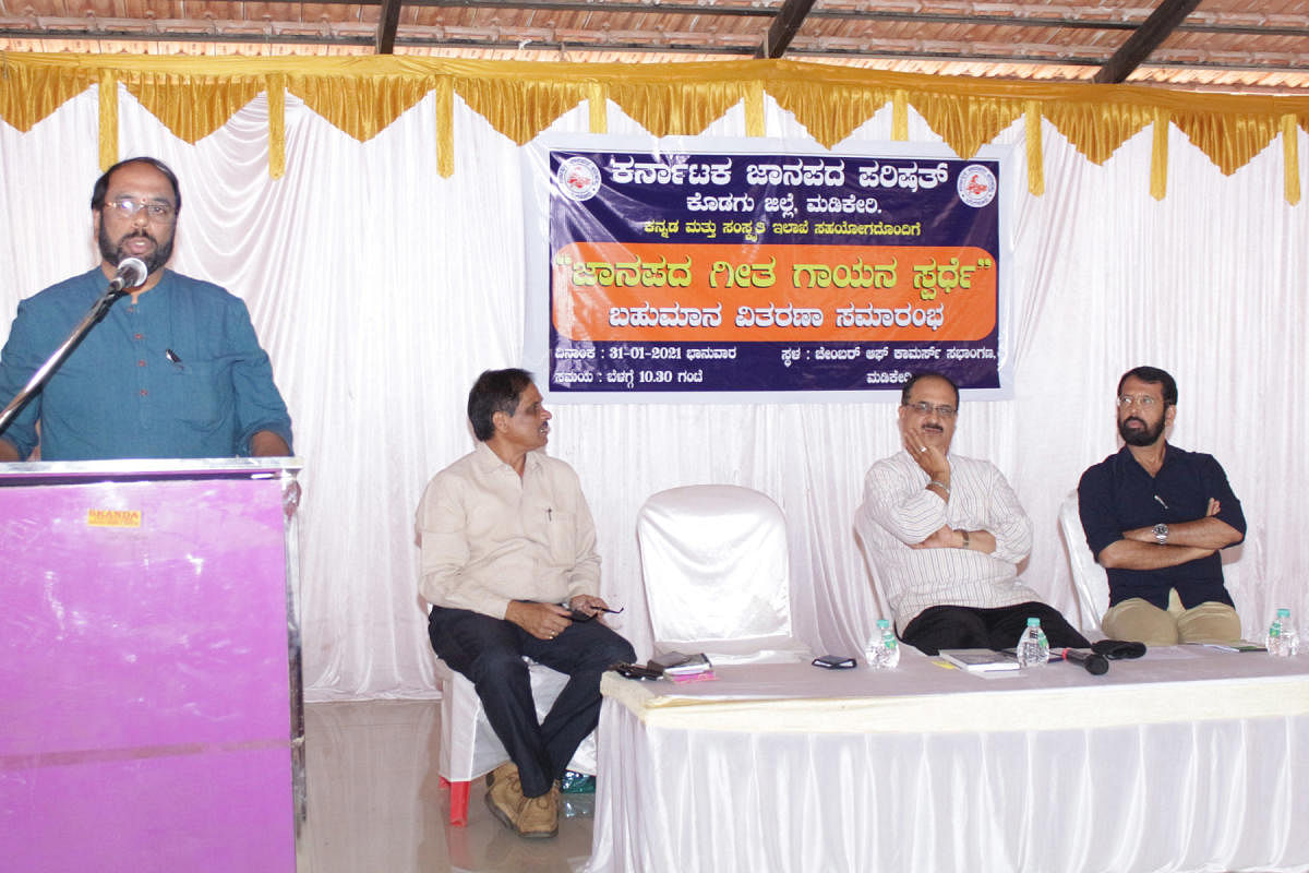 Government First Grade College, Kushalnagar, Art Teacher U R Nagesh, speaks at a programme organised by Janapada Parishat, at the Chamber of Commerce auditorium, on Monday.