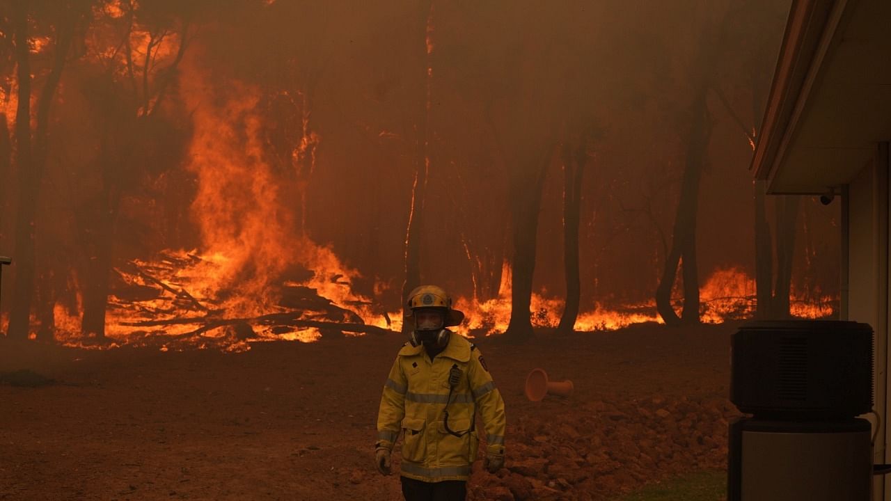 A Department Of Fire and Emergency Services fire fighter battles a bushfire in Brigadoon, Perth. Credit: Reuters Photo