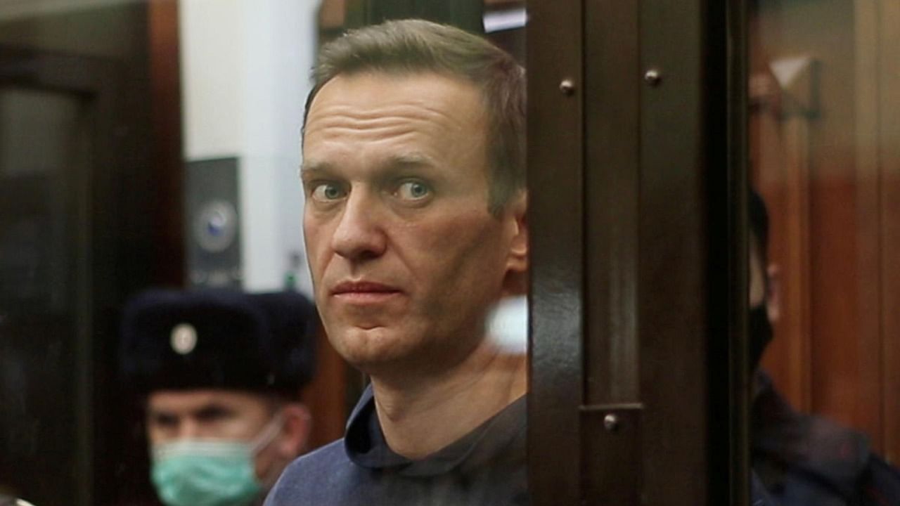 A still image taken from video footage shows Russian opposition leader Alexei Navalny, who is accused of flouting the terms of a suspended sentence for embezzlement, inside a defendant dock during the announcement of a court verdict in Moscow, Russia February 2, 2021. Credit: Press service of Simonovsky District Court/Handout/Reuters.
