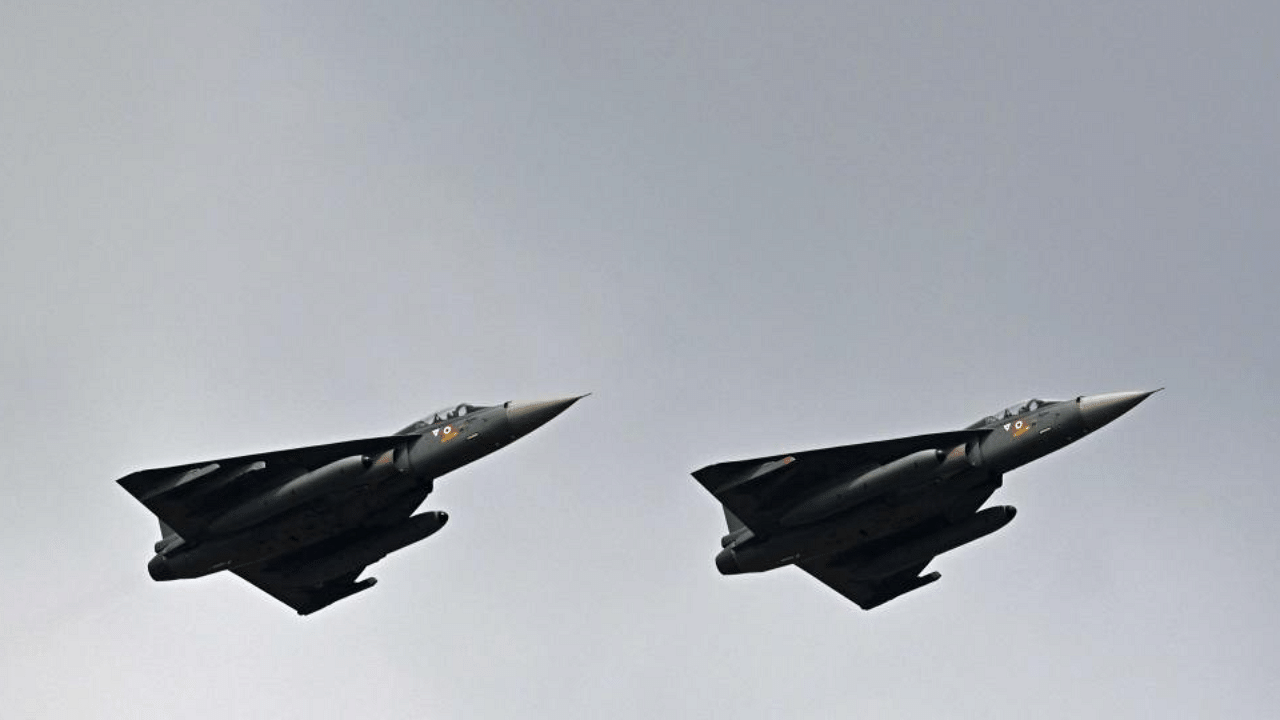 Indian Air Force's Tejas fighter jets perform during the first day of the Aero India 2021 Airshow at the Yelahanka Air Force Station in Bangalore on February 3, 2021. Credit: AFP Photo