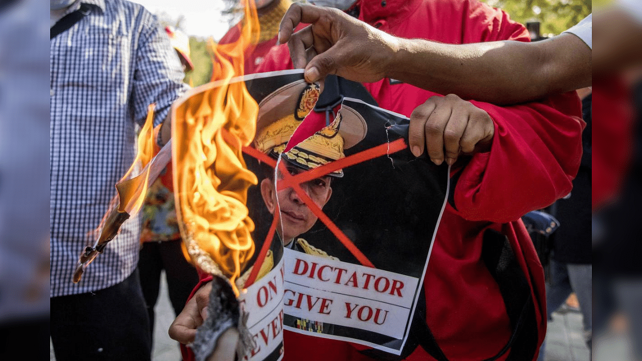 Protesters burn an image of Myanmar's army chief General Min Aung Hlaing in front of the United Nations building in Bangkok on February 3, 2021, during a demonstration against the military coup in Myanmar which saw civilian leader Aung San Suu Kyi being detained. Credit: AFP Photo