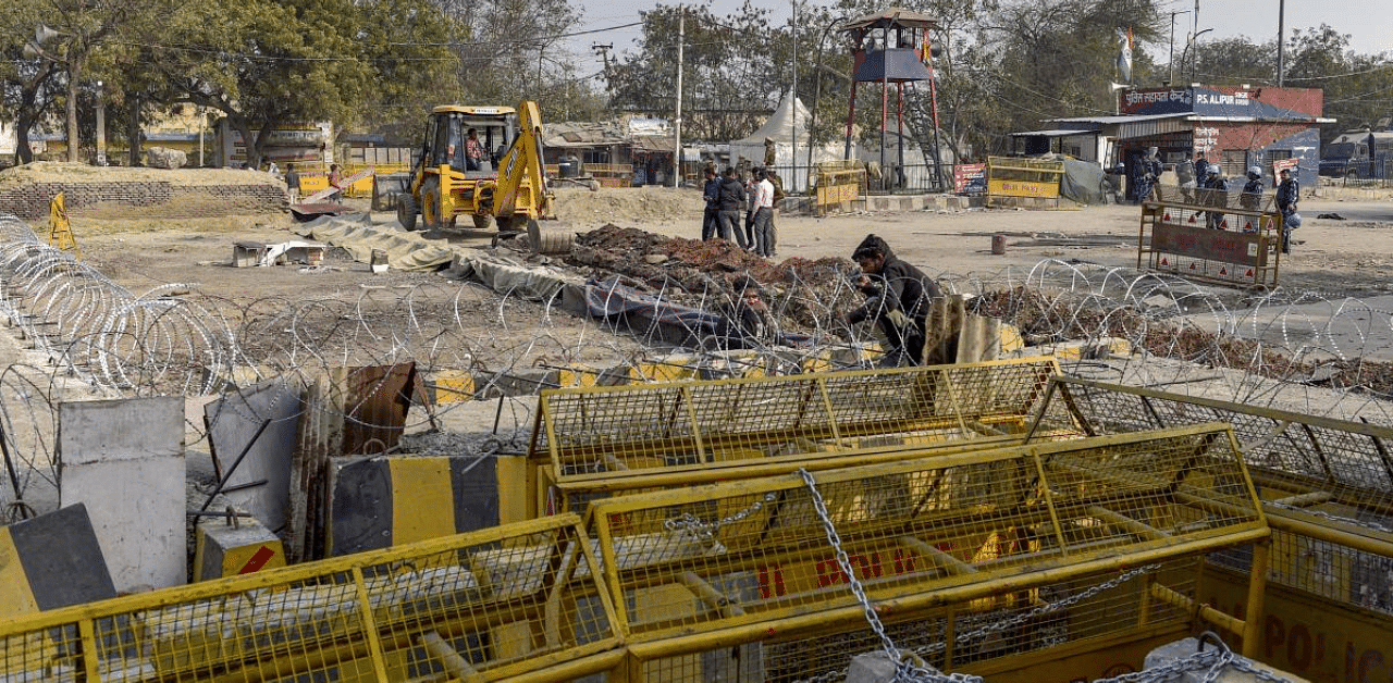 Barbed wiresand barricades put across a road to stop farmers during their protest against new farm law at Singhu border, in New Delhi. Credit: PTI Photo