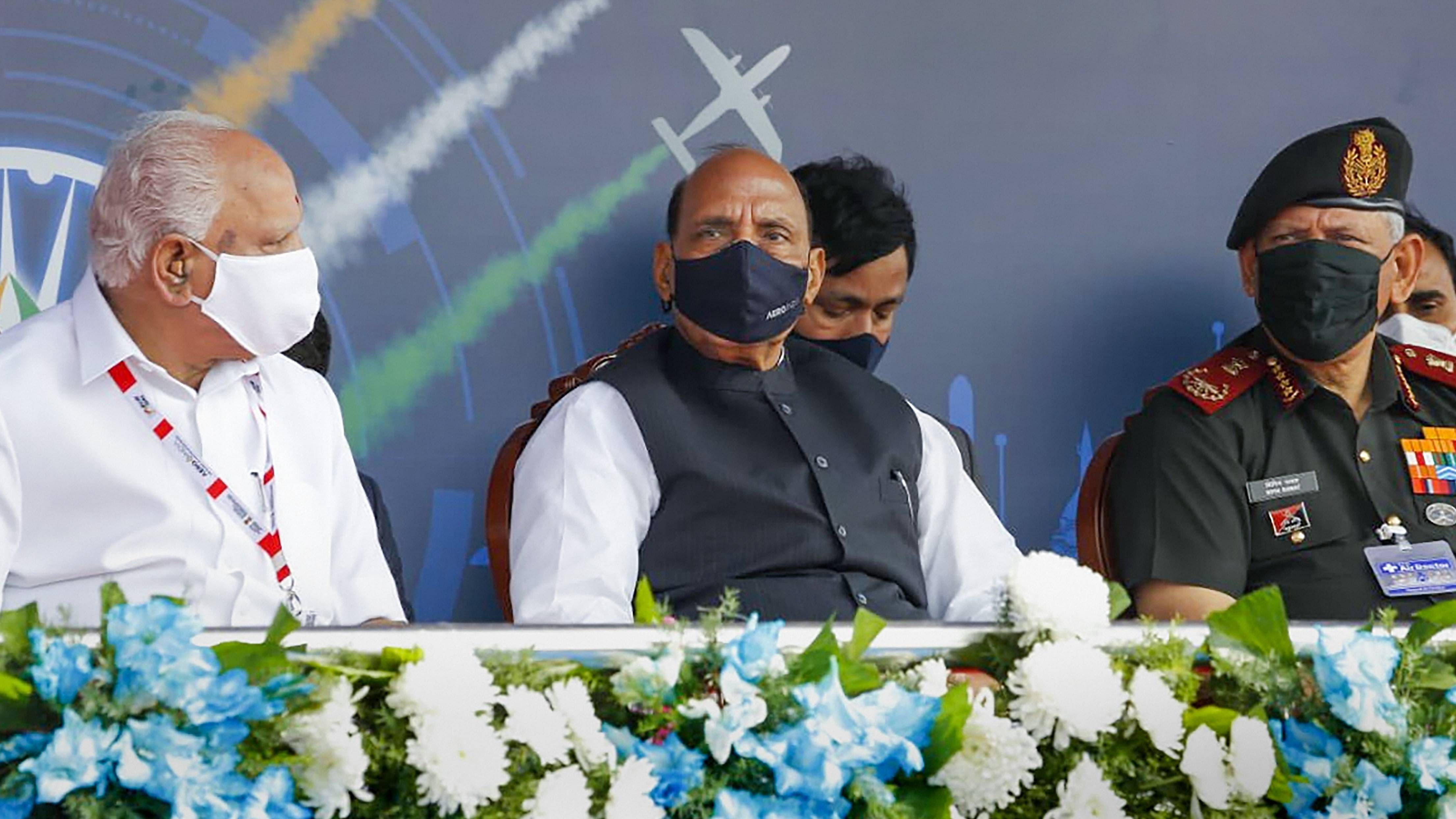 Defence Minister Rajnath Singh along with Karnataka CM BS Yediyurappa and CODS Gen Bipin Rawat during the inaugural ceremony of Aero India 2021 show, in Bengaluru. Credit: PTI