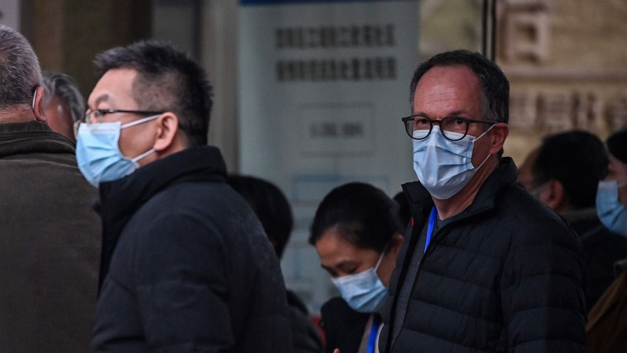 Peter Ben Embarek (R), a food safety scientist with the World Health Organization (WHO), leaves with other members of the WHO team investigating the origins of the COVID-19 coronavirus, after visiting the Jiangxinyuan community centre in Wuhan in China's central Hubei province. Credit: AFP Photo.