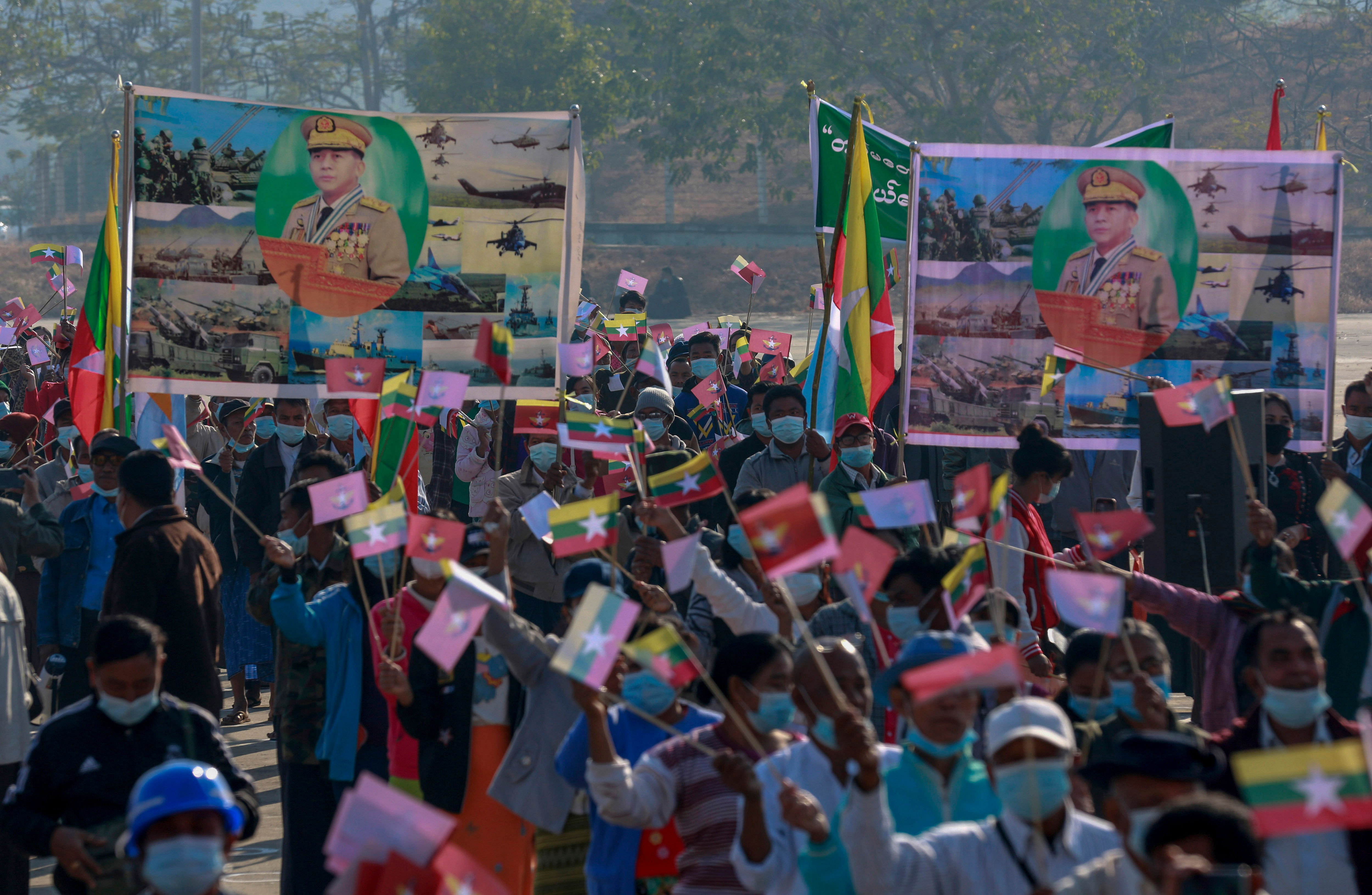 Supporters of Myanmar military wave Myanmar national flags and pictures of Myanmar military Commander-in-Chief Senior Gen. Min Aung Hlaing during a rally supporting military coup in Naypyitaw. Credit: AP Photo