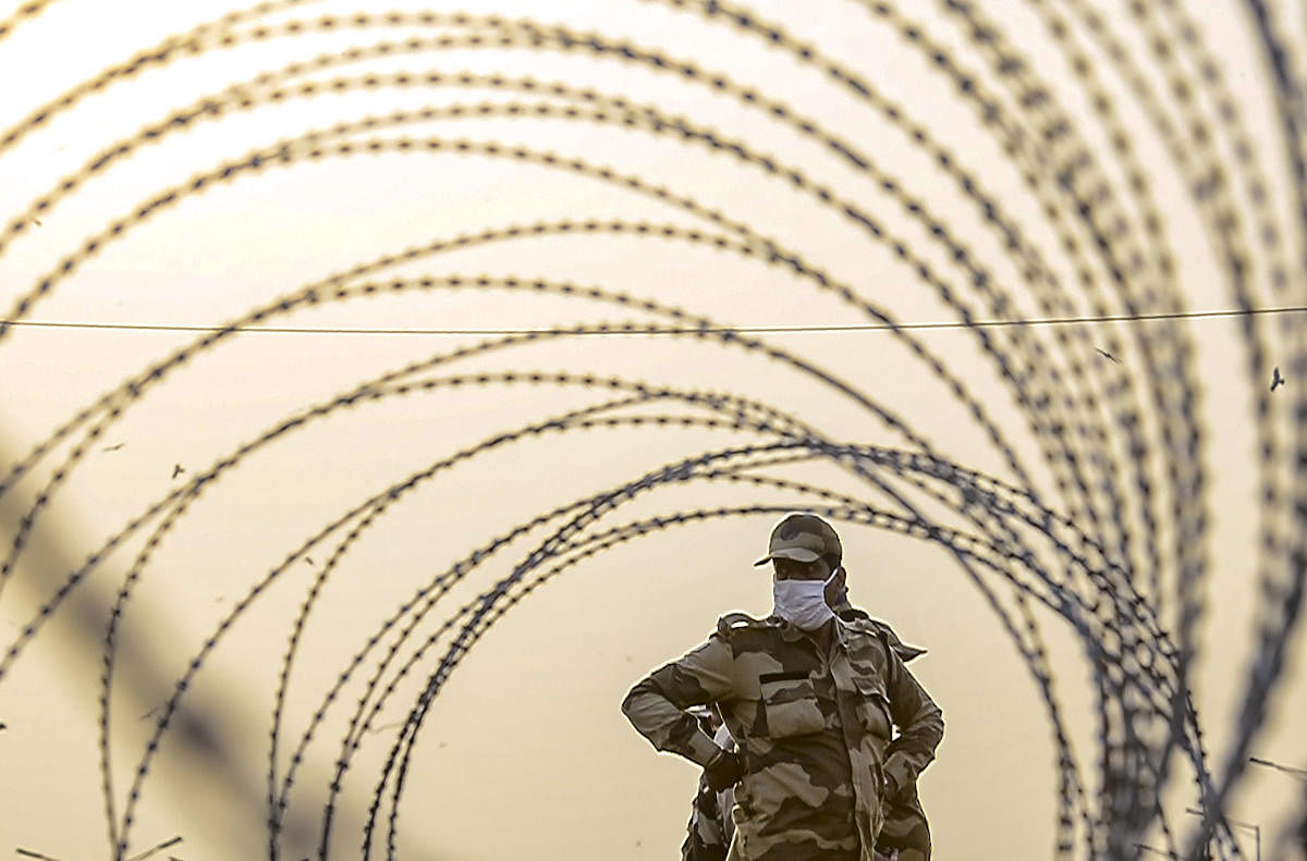 New Delhi: Barbed wires put across a road by Delhi Police to stop farmers from entering the national capital during their protest against the new farm laws, at Ghazipur border in New Delhi, Wednesday, Feb. 3, 2021. Credit: PTI photo. 