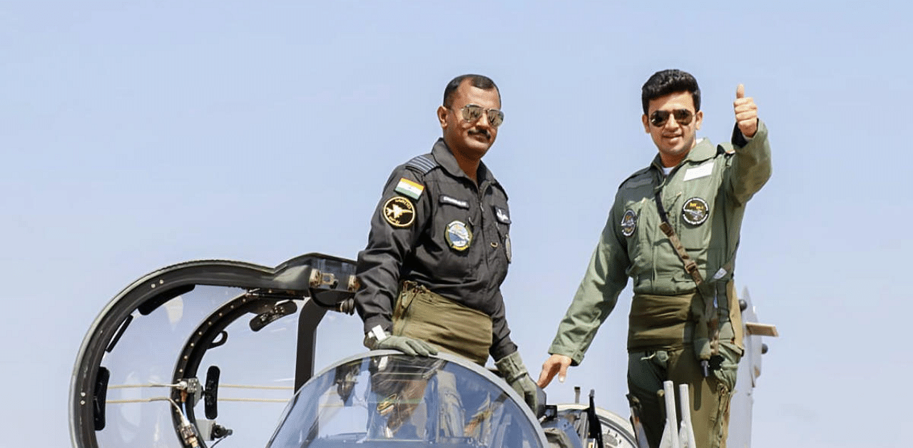  BJP MP Tejasvi Surya gestures as he boards a Light Combat Aircraft Tejas for a sortie during Aero India 2021, in Bengaluru. Credit: PTI Photo