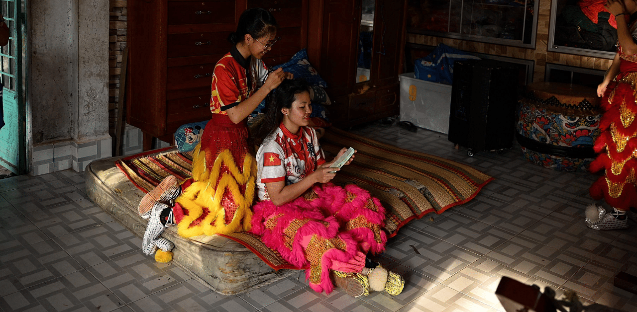  female dancers getting ready for a practice session at the Tu Anh Duong lion and dragon dance school in Can Tho city in southern Vietnam's Mekong Delta. Credit: AFP Photo