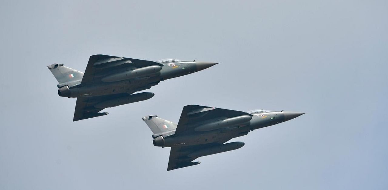 Indian Air Force Light Combat Aircraft Tejas fly in formation during the first day of the Aero India 2021 Airshow at the Yelahanka Air Force Station in Bangalore on February 3, 2021. Credit: AFP Photo