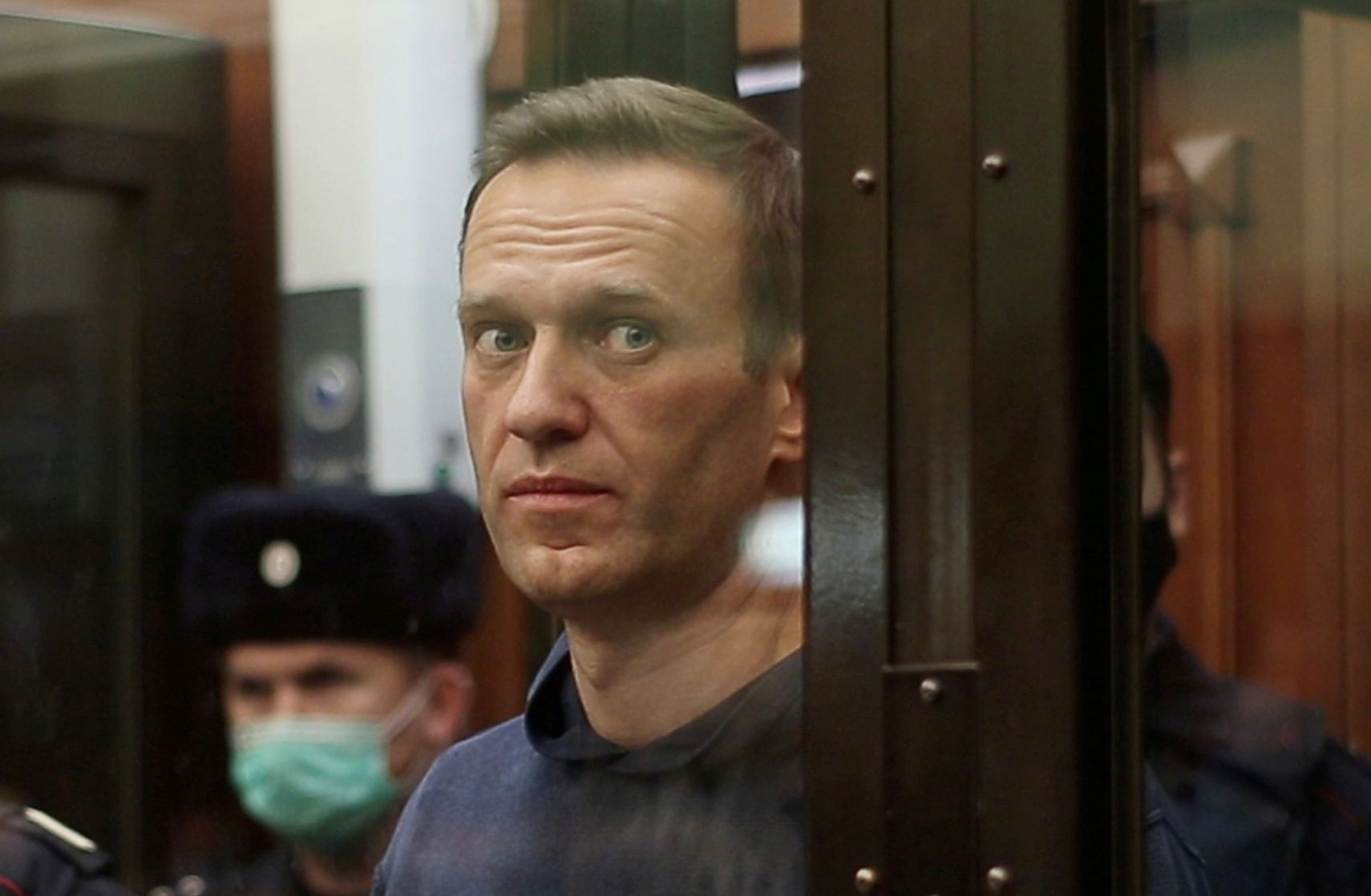 A still image taken from video footage shows Russian opposition leader Alexei Navalny, who is accused of flouting the terms of a suspended sentence for embezzlement, inside a defendant dock during the announcement of a court verdict in Moscow, Russia February 2, 2021. Credit: Press service of Simonovsky District Court/Handout via REUTERS