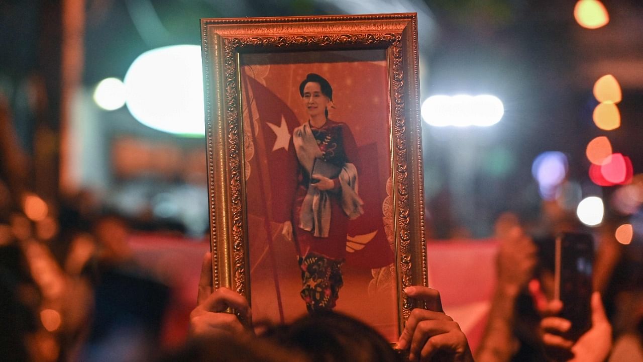 A protester holds a framed image of the detained Myanmar civilian leader Aung San Suu Kyi during a demonstration condemning the military coup outside the Myanmar embassy in Bangkok. Credit: AFP Photo