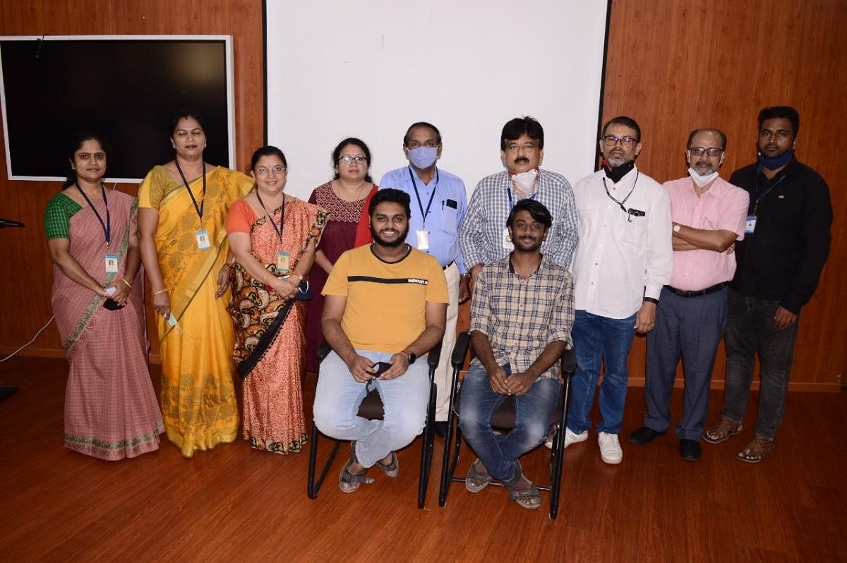 Principal H V Ravindra felicitates the students of PES College of Engineering, Mandya, who won a prize in the South India level Hackmania competition, recently.