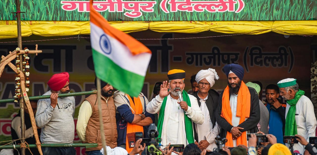 Bharatiya Kisan Union Spokesperson Rakesh Tikait addresses farmers during their protest against new farm laws at Ghazipur border, in New Delhi. Credit: PTI photo. 