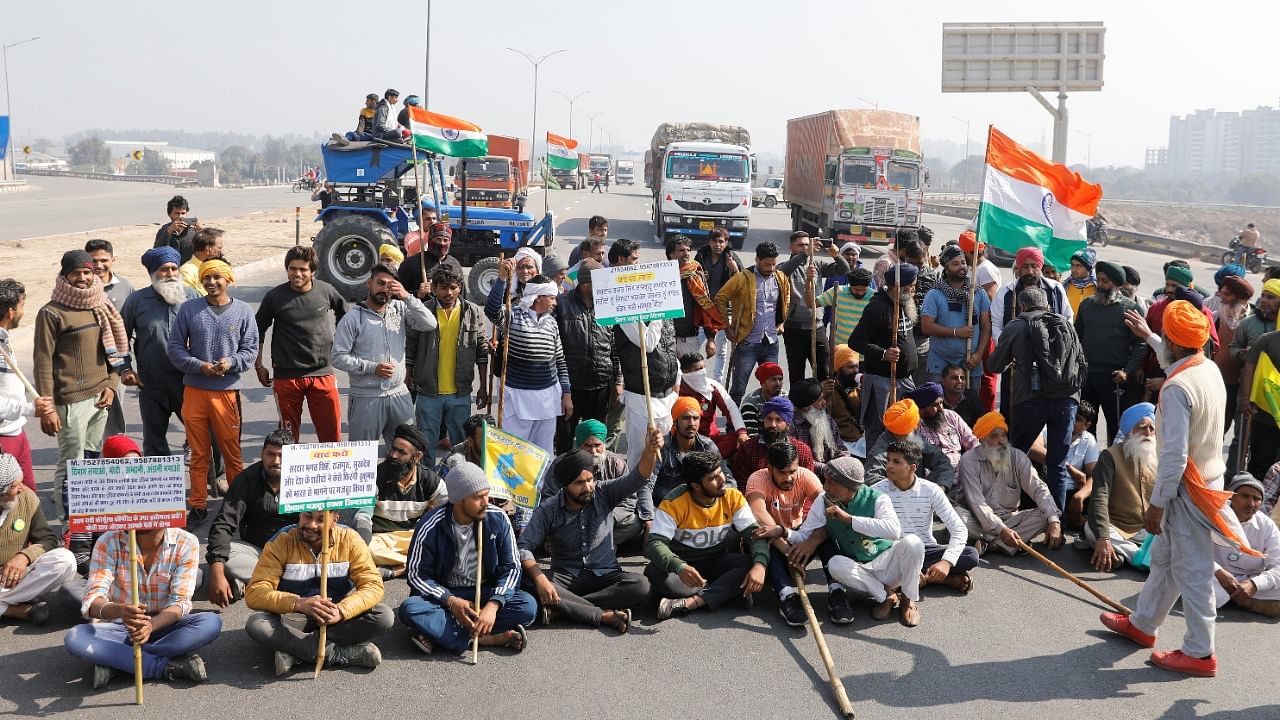 Farmers take part in a three-hour "chakka jam" or road blockade, as part of protests against farm laws on a highway on the outskirts of New Delhi. Credit: Reuters Photo