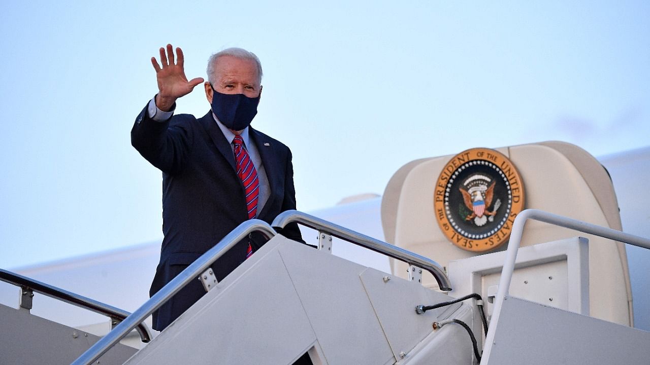 US President Joe Biden waves as he boards Air Force One before departing from Andrews Air Force Base in Maryland. Credit: AFP Photo.