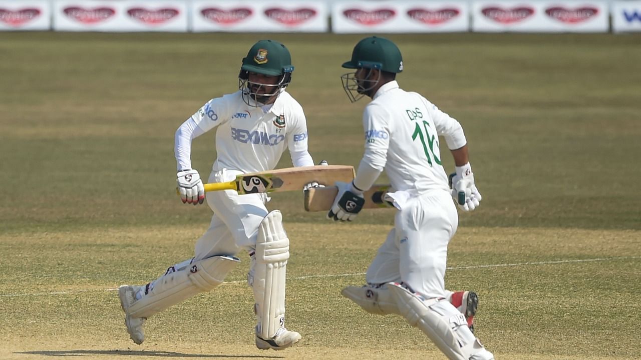 Bangladesh's Mominul Haque (L) and his teammate Liton Das run between the wicket during the fourth day of the first cricket Test match between Bangladesh and West Indies at the Zohur Ahmed Chowdhury Stadium in Chittagong. Credit: AFP Photo.
