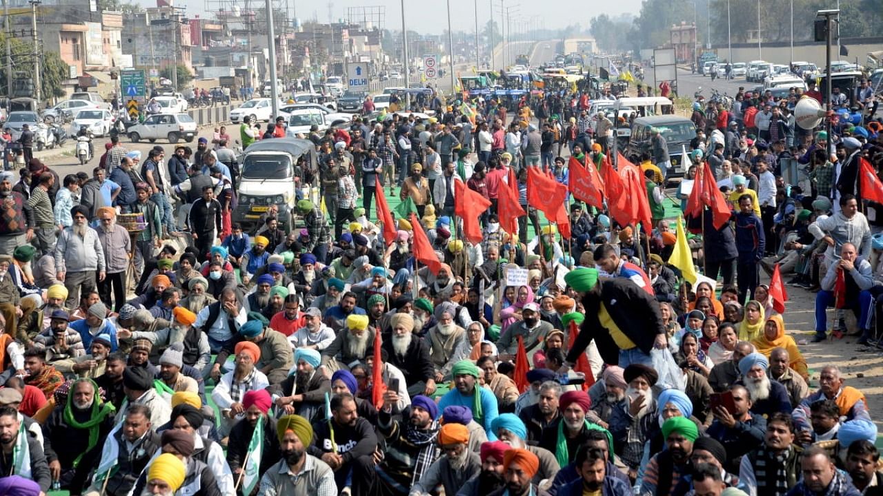Farmers block Jalandhar-New Delhi National Highway during their 'chakka jam' protest as part of the ongoing agitation over new farm laws, in Jalandhar. Credit: PTI.