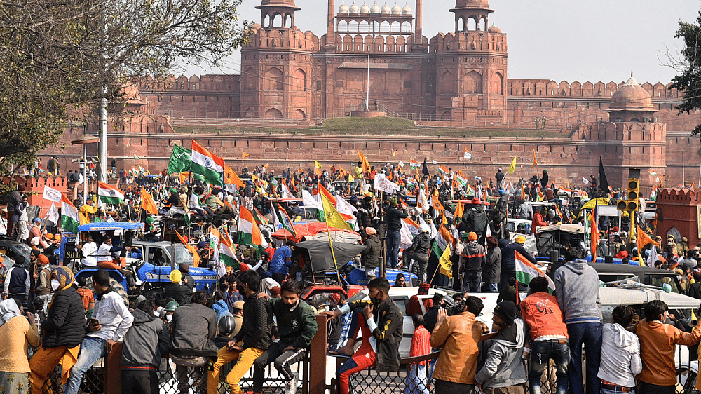 Farmers gather at Red Fort during their tractor parade on Republic Day. Credit: PTI Photo