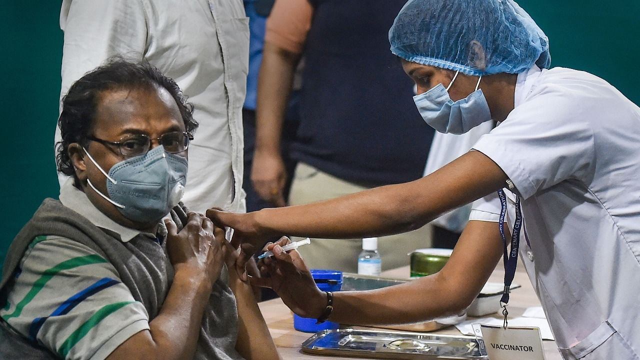  A medic inoculates the first dose of Covid-19 vaccine to a health worker at a government hospital in Kolkata. Credit: PTI File Photo.