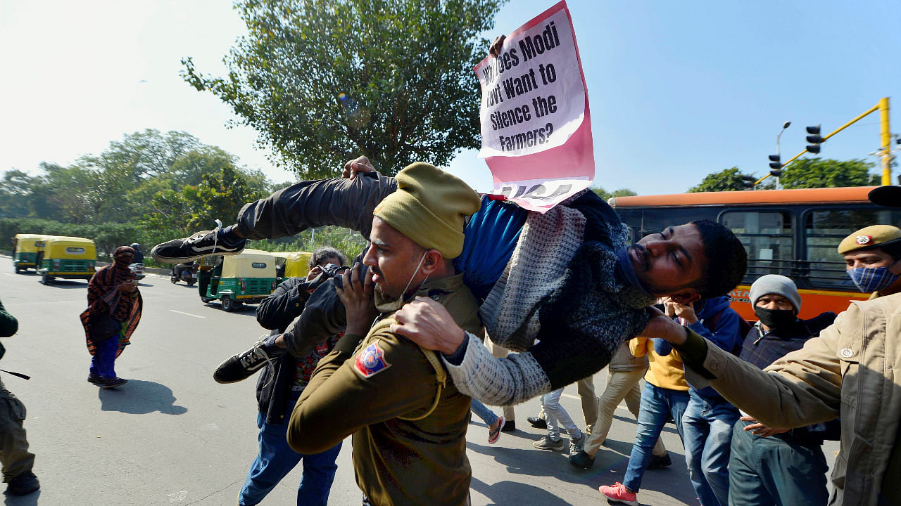 Police detain left-wing activists during a protest to support the ongoing farmers' agitation against Centre's farm reform laws, at Shaheed Park in New Delhi. Credit: PTI Photo
