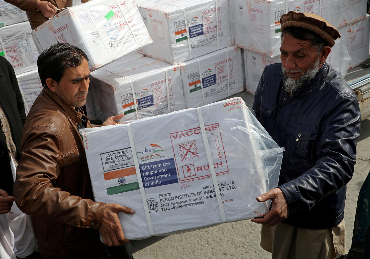 Workers from Afghan health ministry unload boxes containing vials of COVISHIELD, a coronavirus disease (COVID-19) vaccine donated by Indian government in Kabul, Afghanistan February 7, 2021. Credit: REUTERS