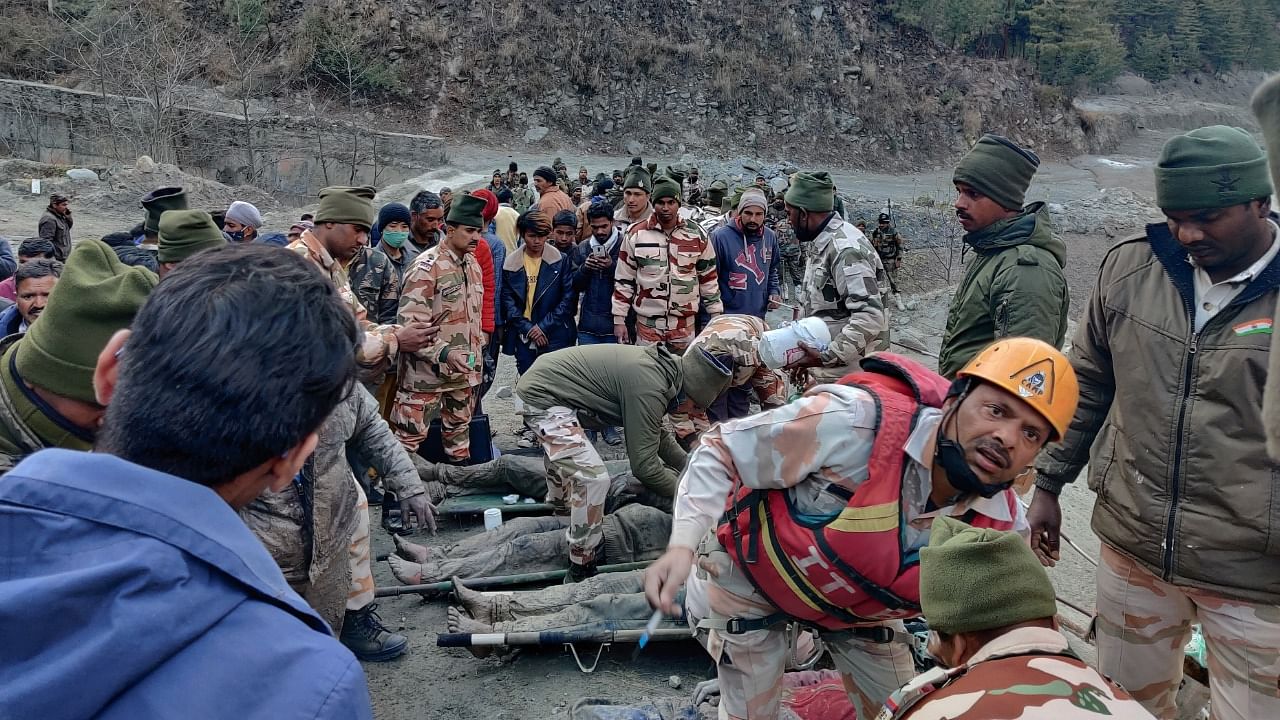 Members of Indo-Tibetan Border Police (ITBP) tend to people rescued after a Himalayan glacier broke and swept away a small hydroelectric dam, in Chormi village in Tapovan in Uttarakhand. Credit: Reuters Photo.