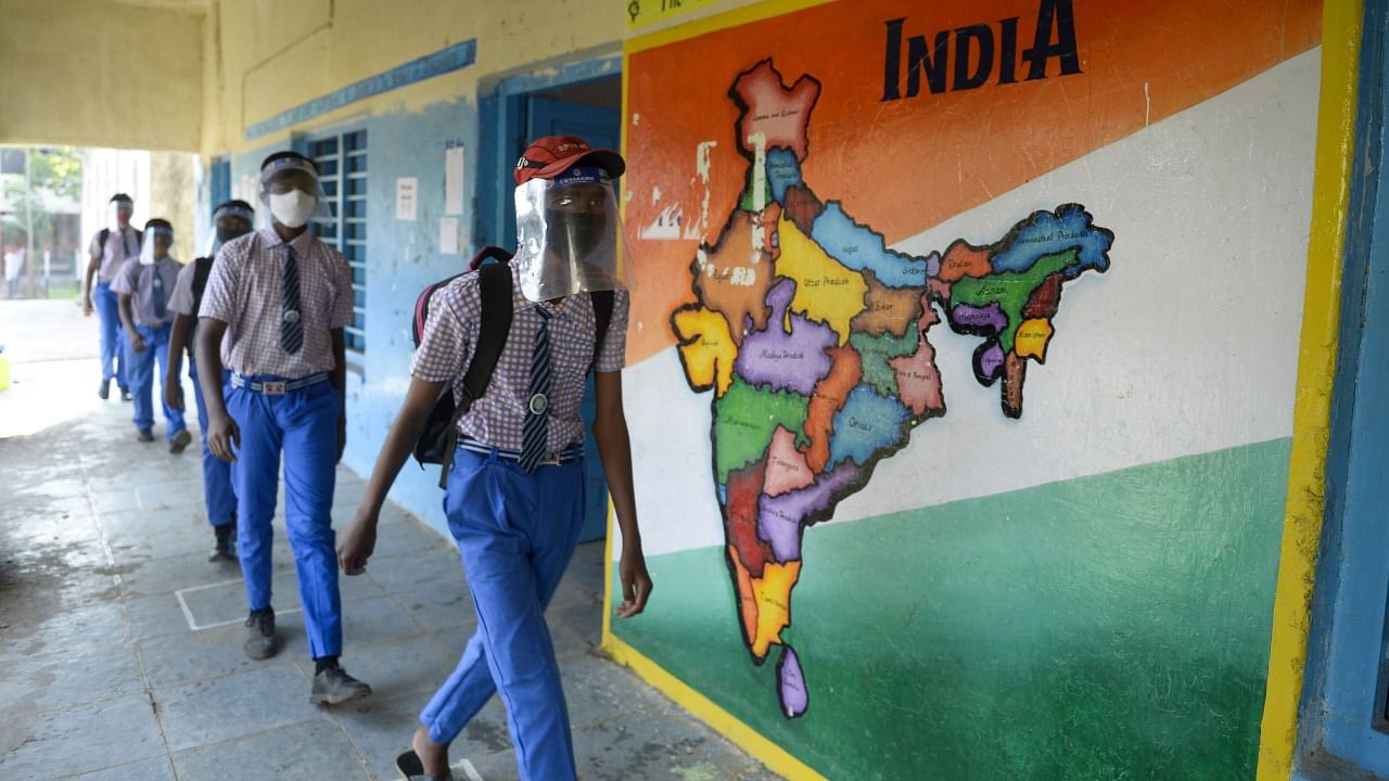 Students wearing facemasks and face-shields arrive after their school reopened for the 9th and 10th grades following nearly ten months closure due to the Covid-19 coronavirus pandemic in Hyderabad on February 6, 2021. Credit: AFP Photo