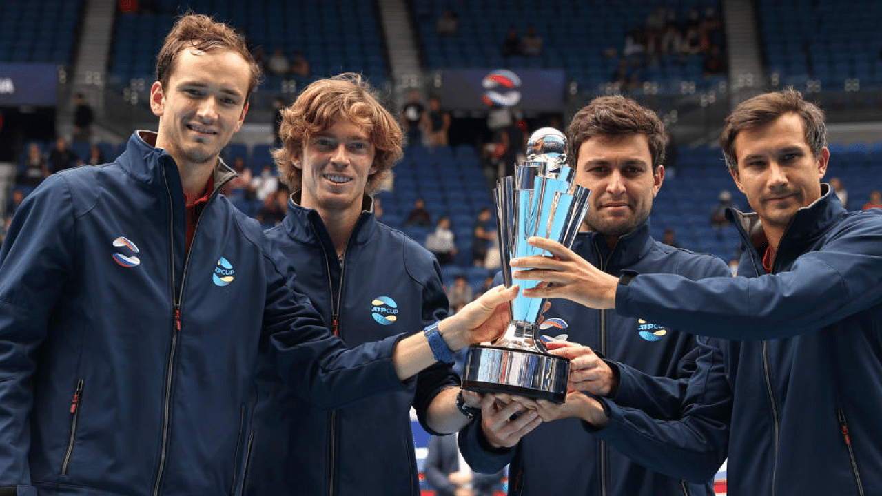 Russia's Daniil Medvedev, Andrey Rublev, Aslan Karatsev and Evgeny Donskoy celebrate winning the ATP Cup with the trophy after their final against Italy. Credit: Reuters Photo