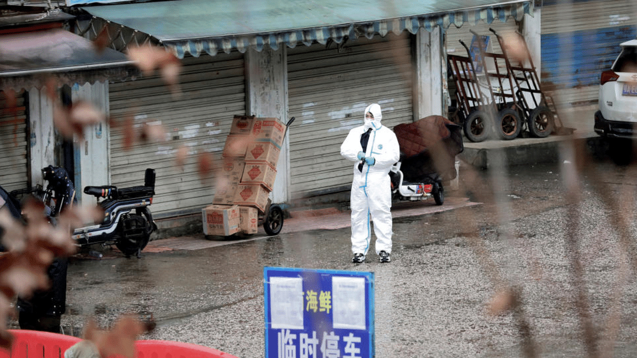  A worker in a protective suit is seen at the closed seafood market in Wuhan, Hubei province, China January 10, 2020. Credit: Reuters File Photo