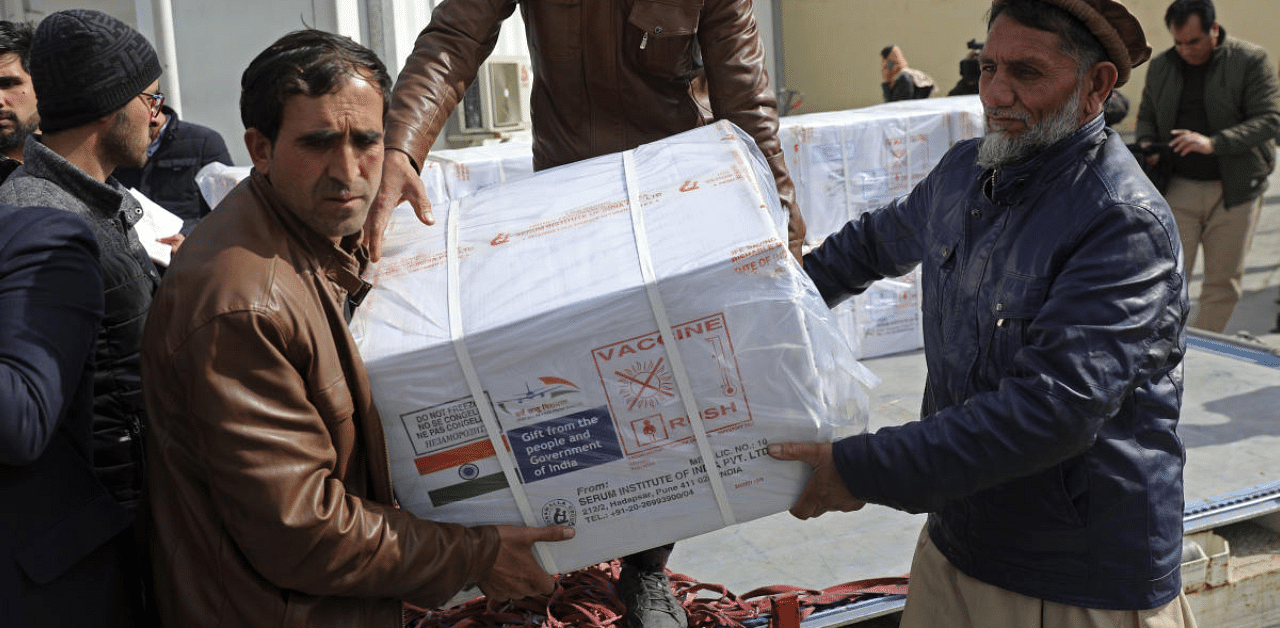 Afghan health ministry workers unloads boxes of the first shipment of 500,000 doses of the AstraZeneca coronavirus vaccine made by Serum Institute of India, donated by the Indian government to Afghanistan. Credit: AP Photo