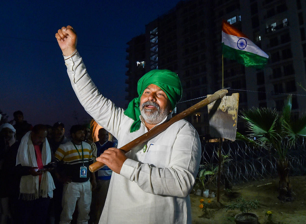 BKU leader Rakesh Tikait holding a spade raises slogans during farmers' ongoing protest against Centre's new farm laws, at Ghazipur border in New Delhi, Saturday, Feb. 6, 2021. Credit: PTI Photo