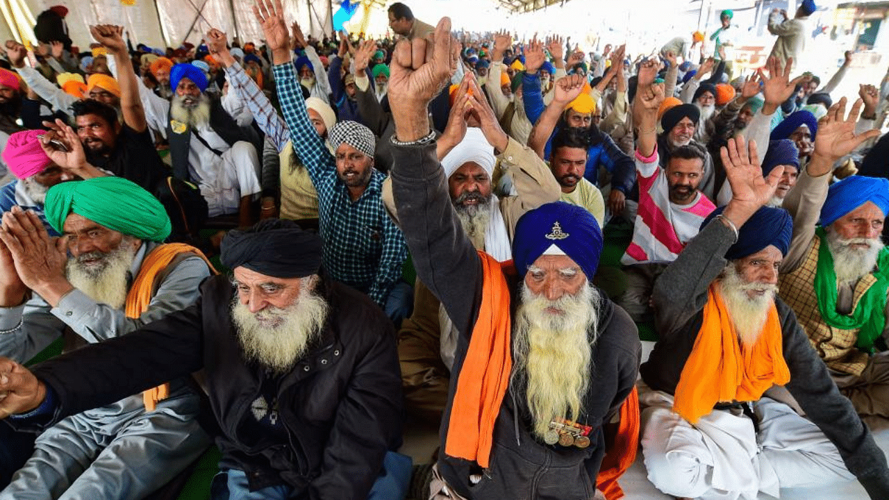  Farmers raise slogans at Singhu border during their protest against farm laws, in New Delhi, Monday, Feb. 8, 2021. Credit: PTI Photo