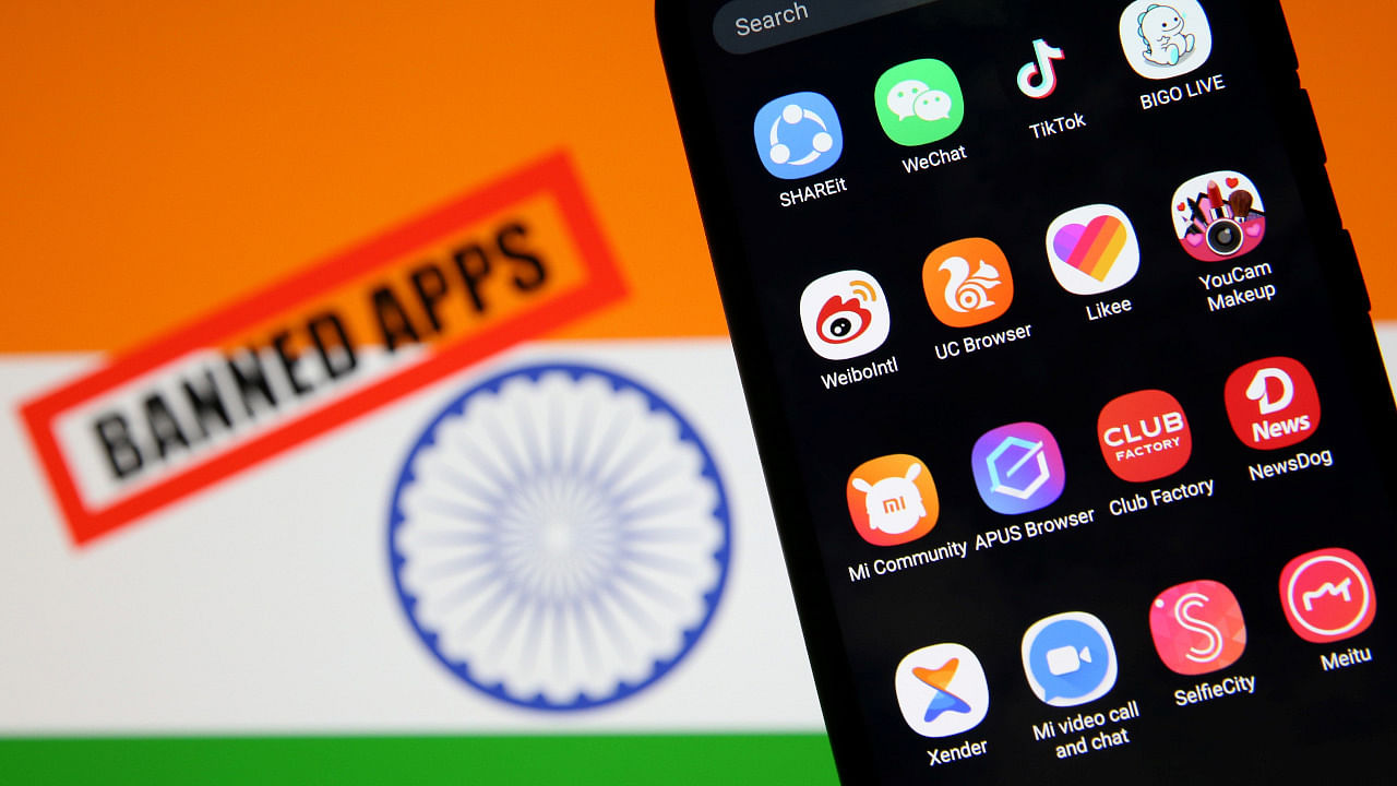 Smartphone with Chinese applications is seen in front of a displayed Indian flag and a "Banned app" sign in this illustration picture taken July 2, 2020. Credit: Reuters Photo
