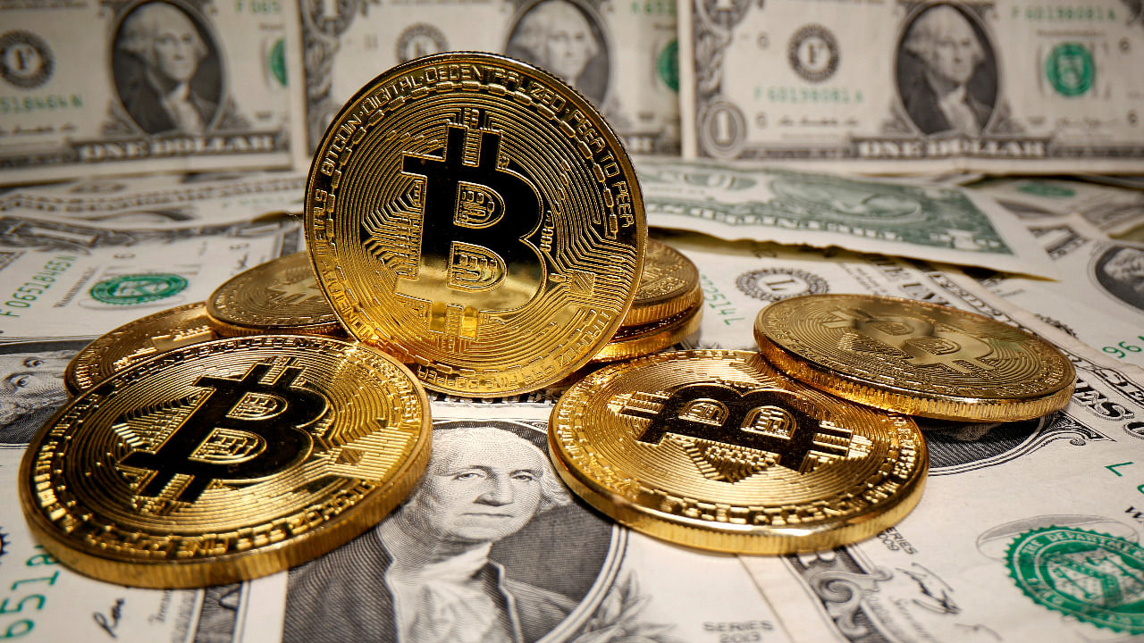 Representations of virtual currency Bitcoin are placed on US Dollar banknotes. Credit: Reuters Photo