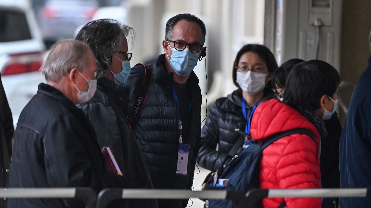 Peter Ben Embarek (C) and other members of the World Health Organization (WHO) team investigating the origins of the Covid-19 coronavirus, visit a local community in Wuhan, China's central Hubei province. Credit: AFP File Photo.