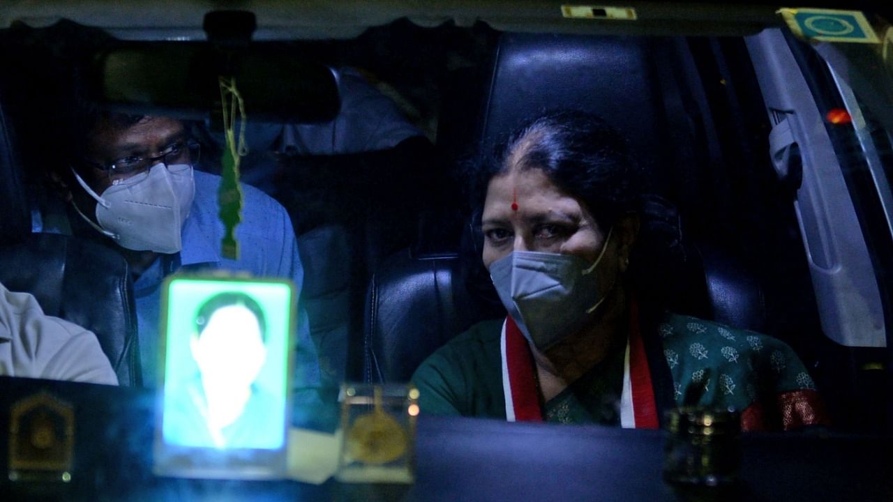 V K Sasikala (R), who in 2017 was expelled from her leadership position in the All India Anna Dravida Munnetra Kazhagam (AIADMK) party and recently released from prison after serving a four-year sentence for corruption, looks on from her vehicle during her arrival in Chennai. Credit: AFP Photo.