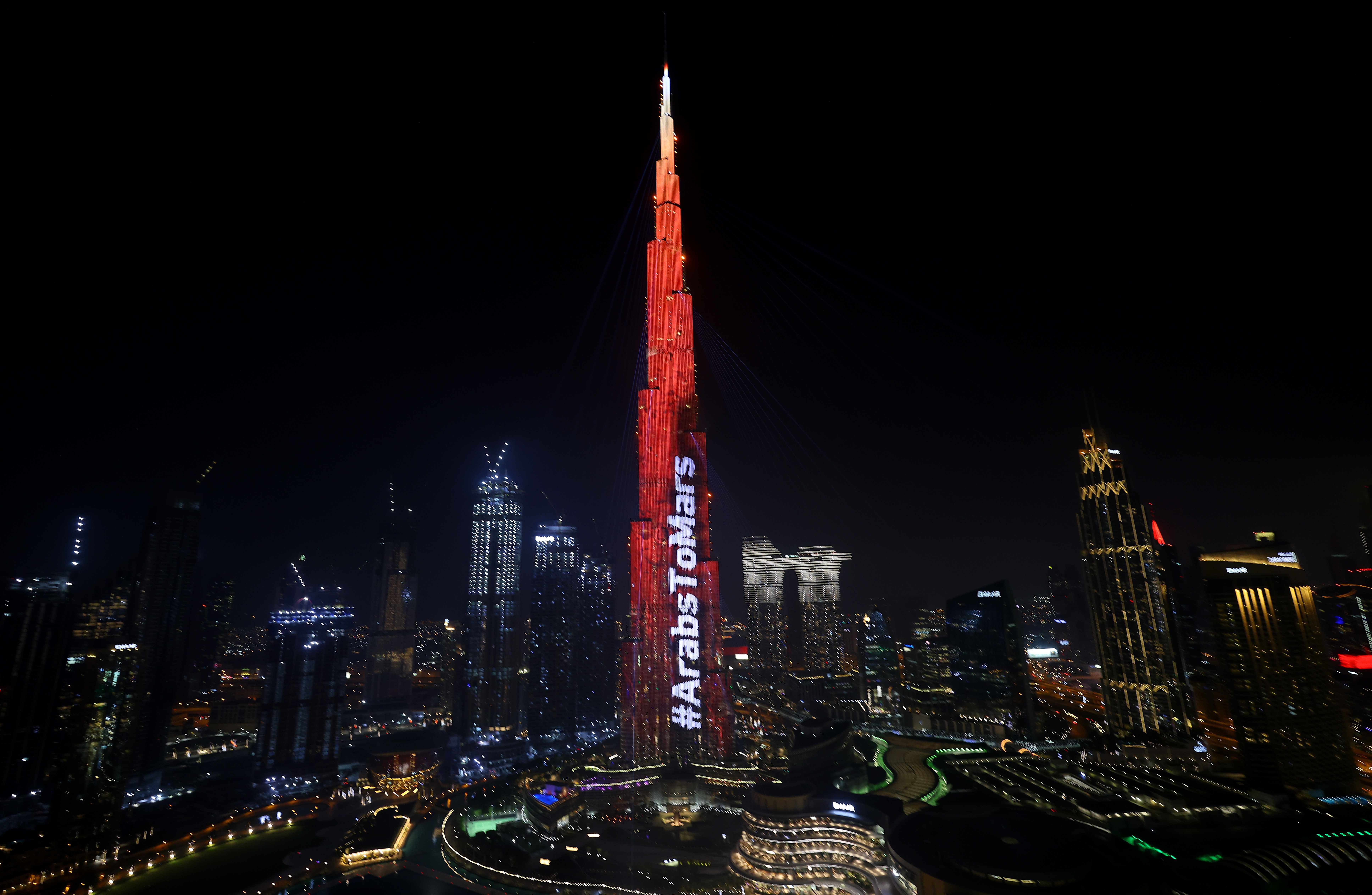 Dubai's Burj Khalifa is lit up in red on February 9, 2021 as the UAE's "Al-Amal" -- Arabic for "Hope" -- probe's to Mars carries out a tricky manoeuvre to enter the Red Planet's orbit. Credit: AFP Photo