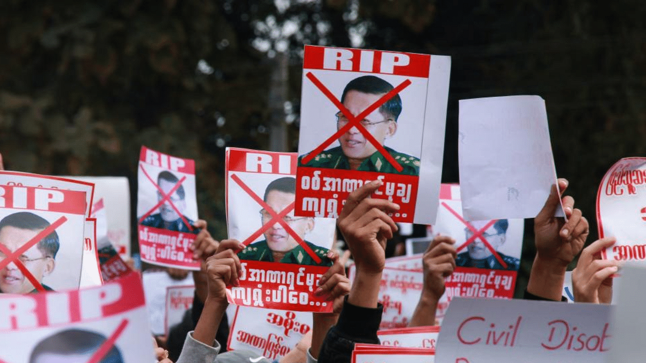 Protesters hold up signs denouncing Myanmar military chief General Min Aung Hlaing as they take part in a demonstration against the military coup in Myitkyina in Myanmar's Kachin state on February 8, 2021. Credit: AFP Photo