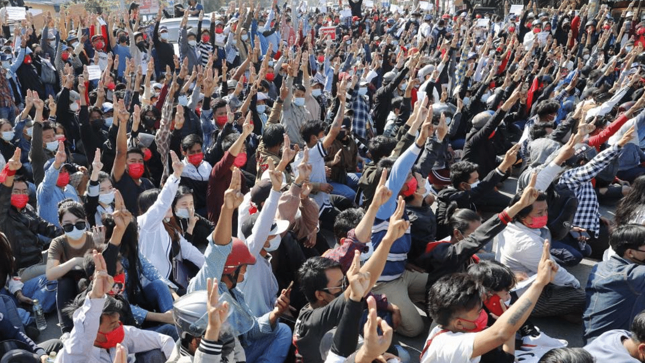 Protesters flash the three-fingered salute, a symbol of resistance, during a protest in Mandalay, Myanmar, Tuesday, Feb. 9, 2021. Credit: AP Photo