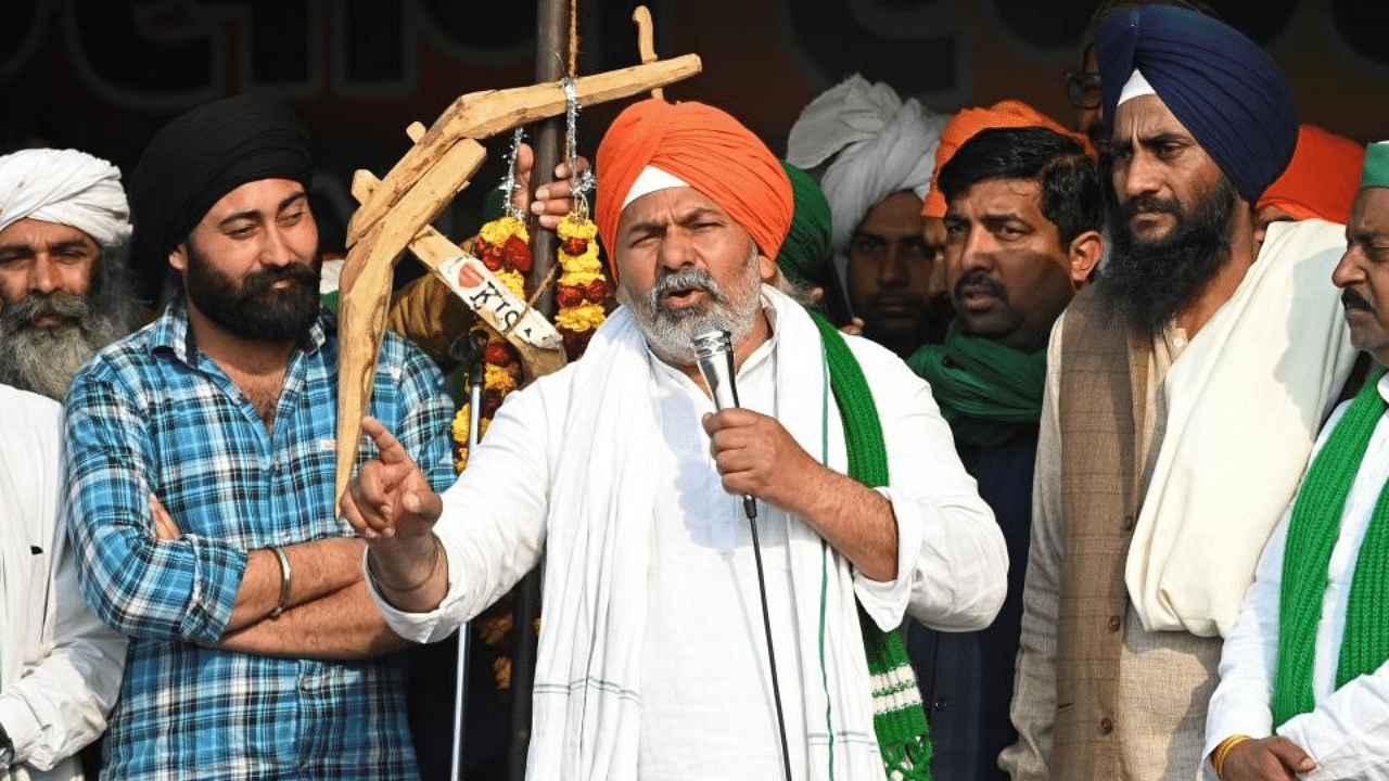 Bharatiya Kisan Union (BKU) leader Rakesh Tikait (C) talks to farmers taking part in a protest against the central government's recent agricultural reforms at the Delhi-Uttar Pradesh state border in Ghazipur. Credit: AFP File Photo