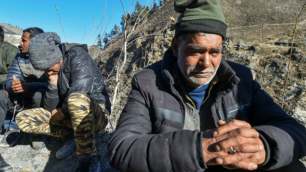 Family members of the workers stuck inside the Tapovan Tunnel, after a glacier broke off in Joshimath causing a massive flood in the Dhauli Ganga river. Credit: PTI Photo